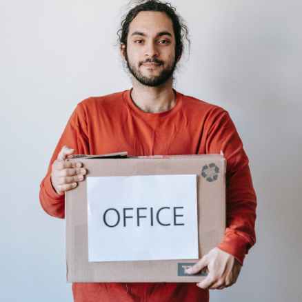 man carrying a box of office materials