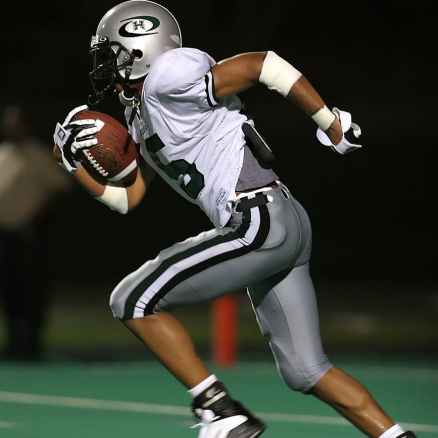 football player holding football