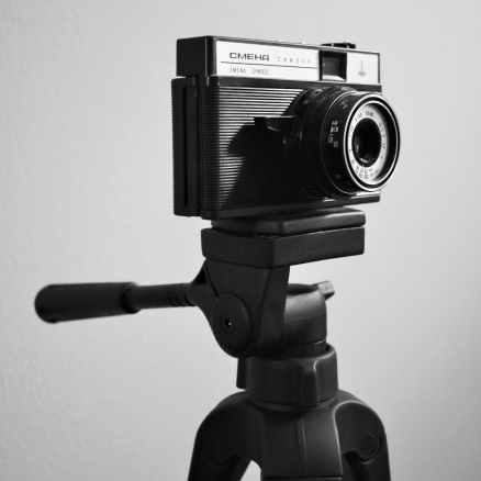 greyscale photo of camera on tripod