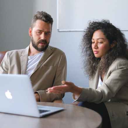 focused man working with female colleague in office