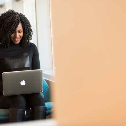 woman holding macbook