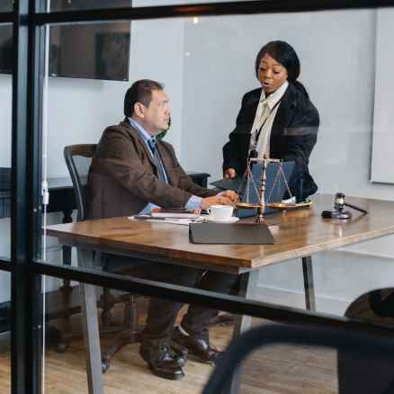 female secretary talking with boss in lawyer office